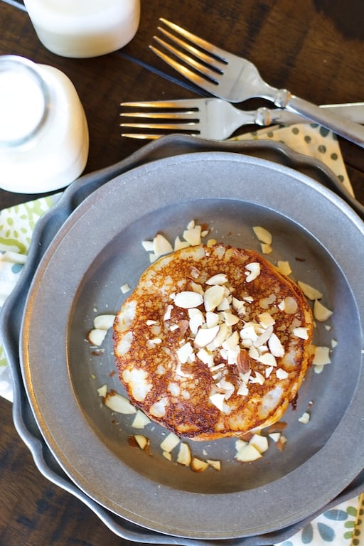 Overhead view of a stack of simple banana pancakes on a metal plate. 