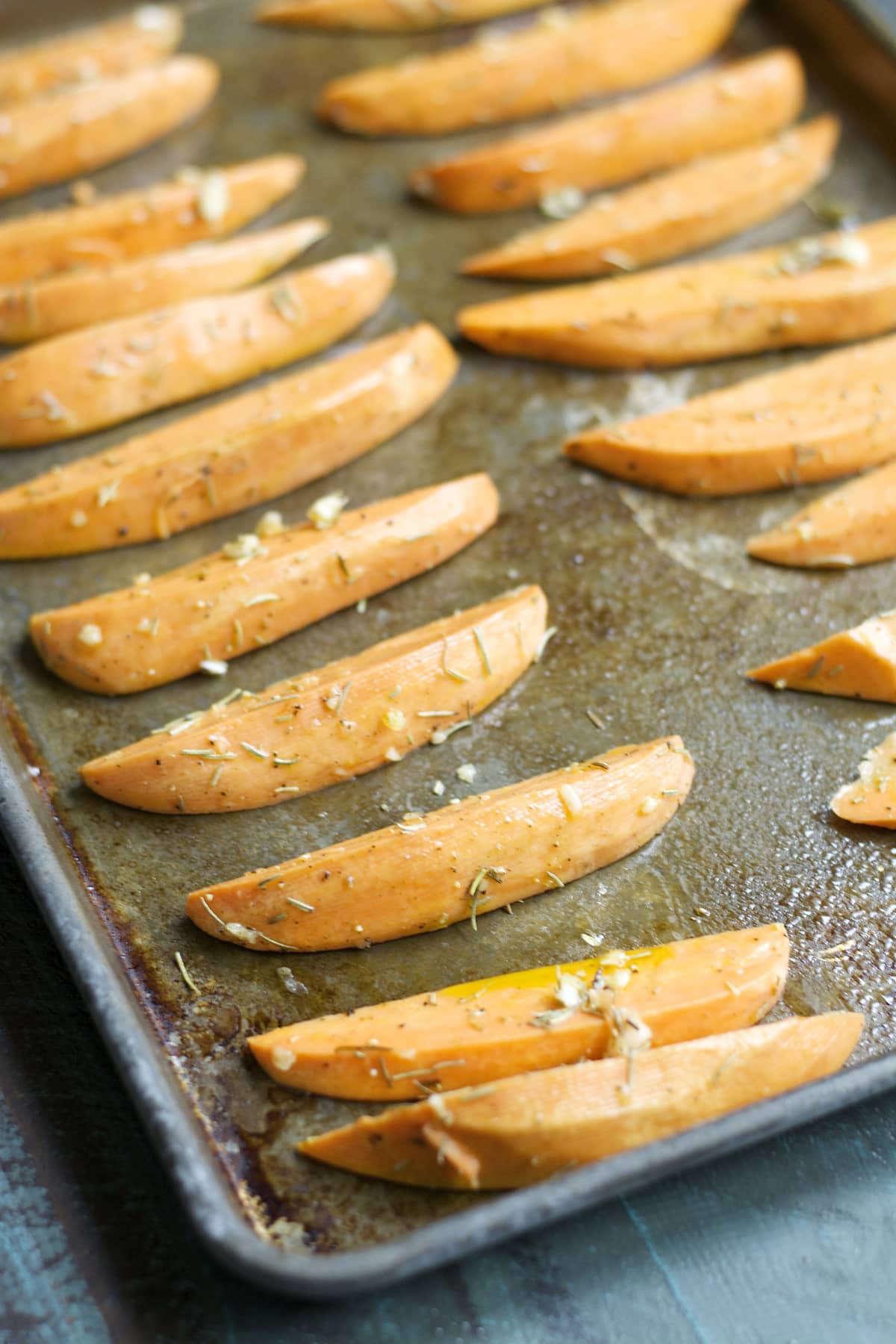 unbaked sweet potato fries on a baking tray