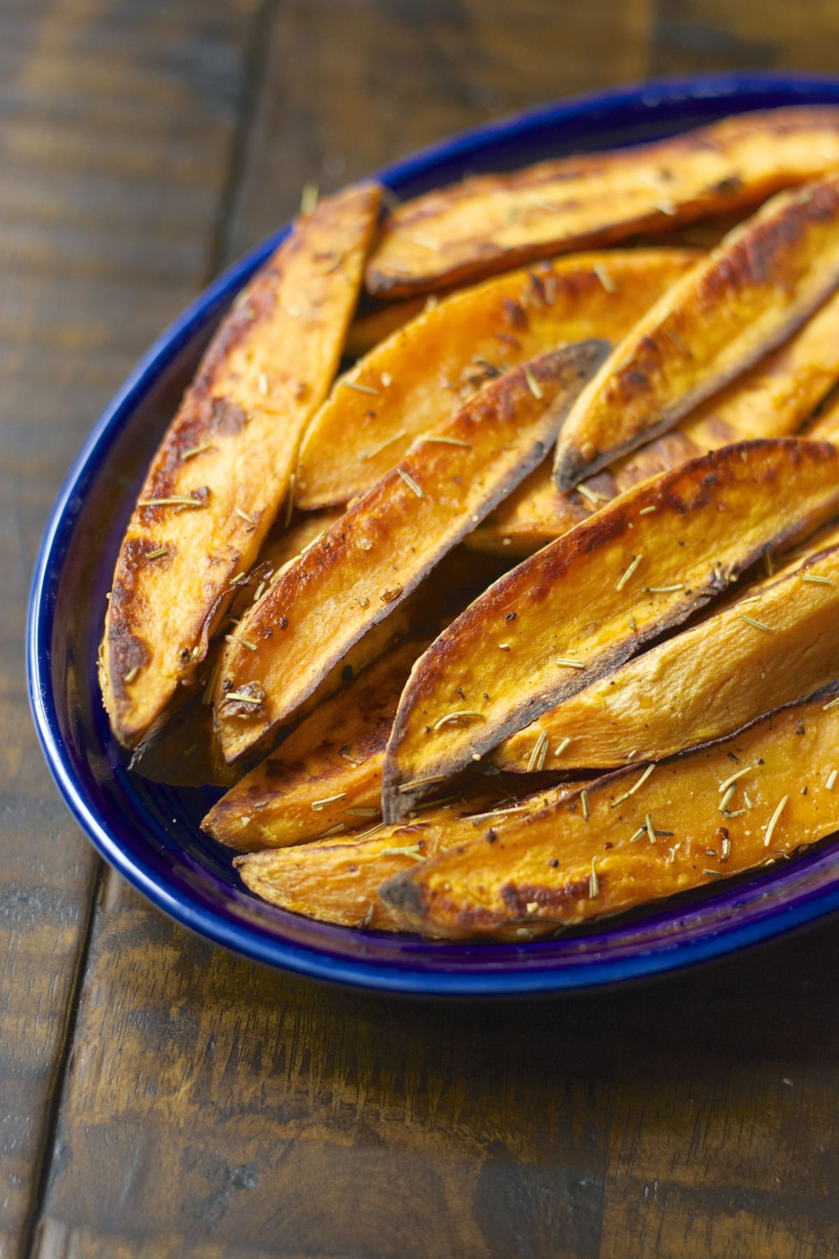 baked sweet potato wedges in a blue dish