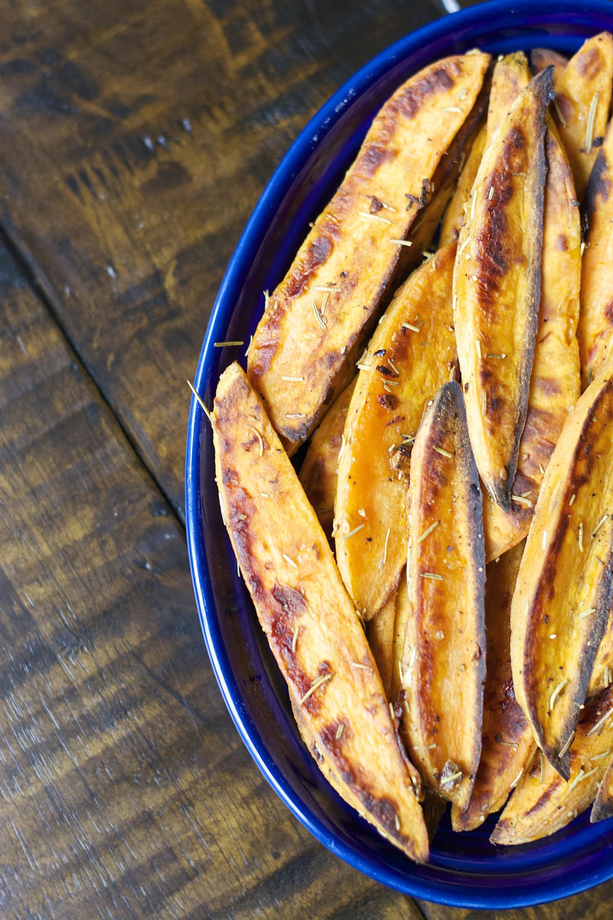 oven baked sweet potato wedges in a blue dish 