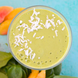 Start your day with a nutritious Mango and Peach Green Smoothie! This smoothie is loaded with frozen fruit and greens for a wholesome drink!