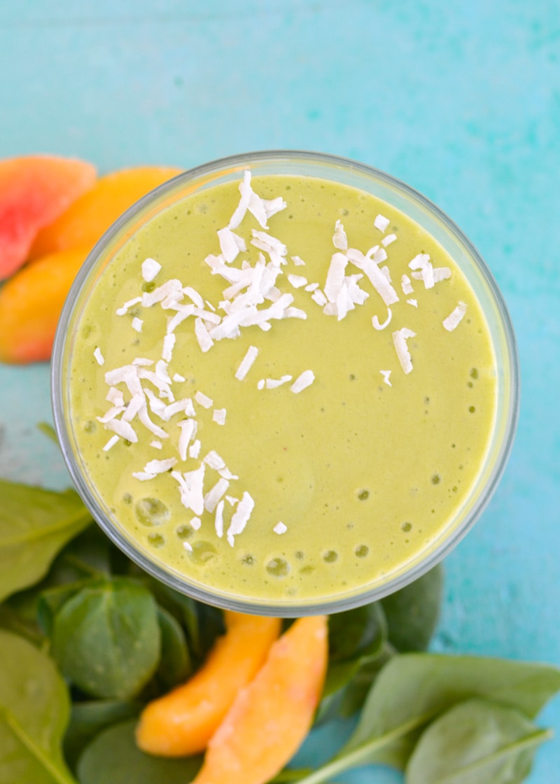 Overhead view of a peach and mango smoothie in a glass. 