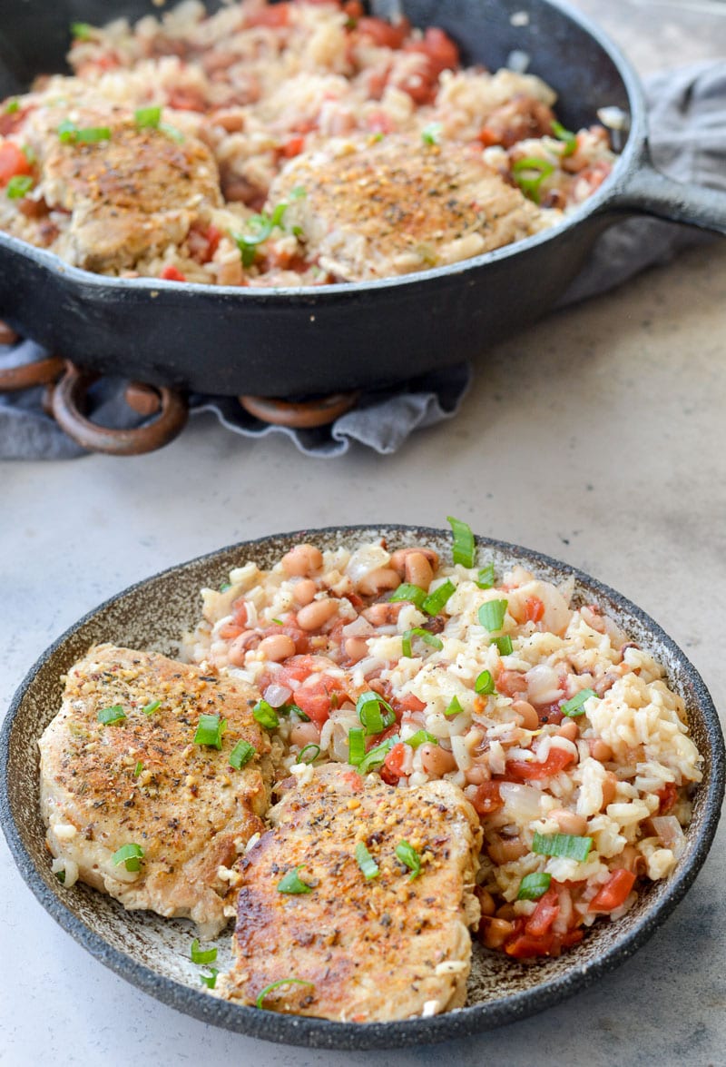 This One-Pan Pork Chops and Rice is loaded with tender rice, black eyed peas and Cajun pork chops. This easy dinner recipe is quick, inexpensive, and easy!