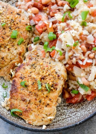 This One Pan Pork Chops and Rice is loaded with tender rice, black eyed peas and cajun pork chops. Packed with pantry staples this is a quick and easy dinner perfect for busy nights!