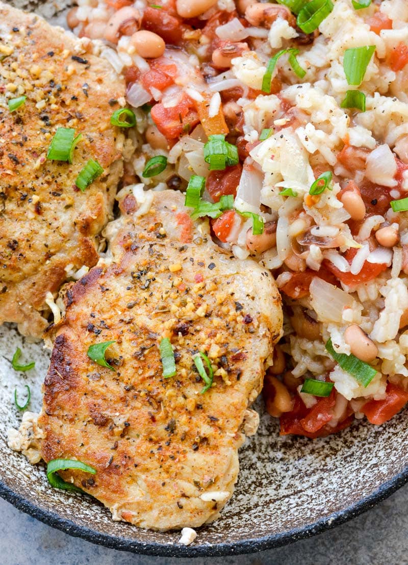 This One-Pan Pork Chops and Rice is loaded with tender rice, black eyed peas and Cajun pork chops. This easy dinner recipe is quick, inexpensive, and easy!