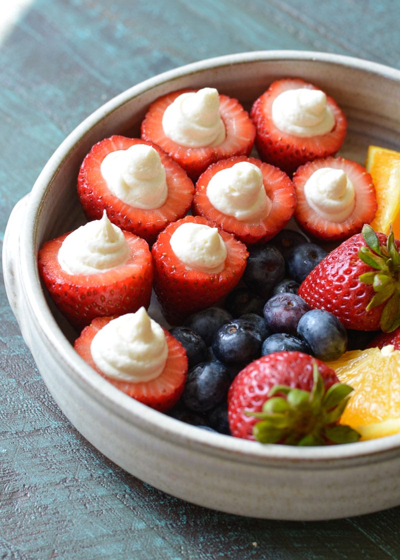 These Cheesecake Stuffed Strawberries look fancy, but they're a breeze to make! Perfect for picnics and potlucks! 