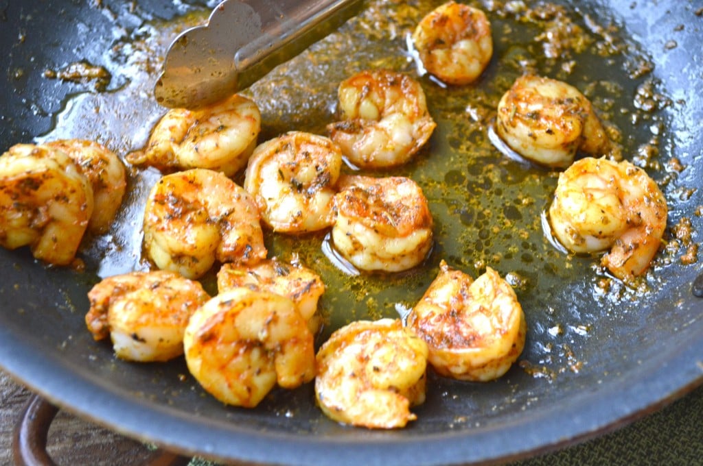 spiced shrimp cooking in a skillet 