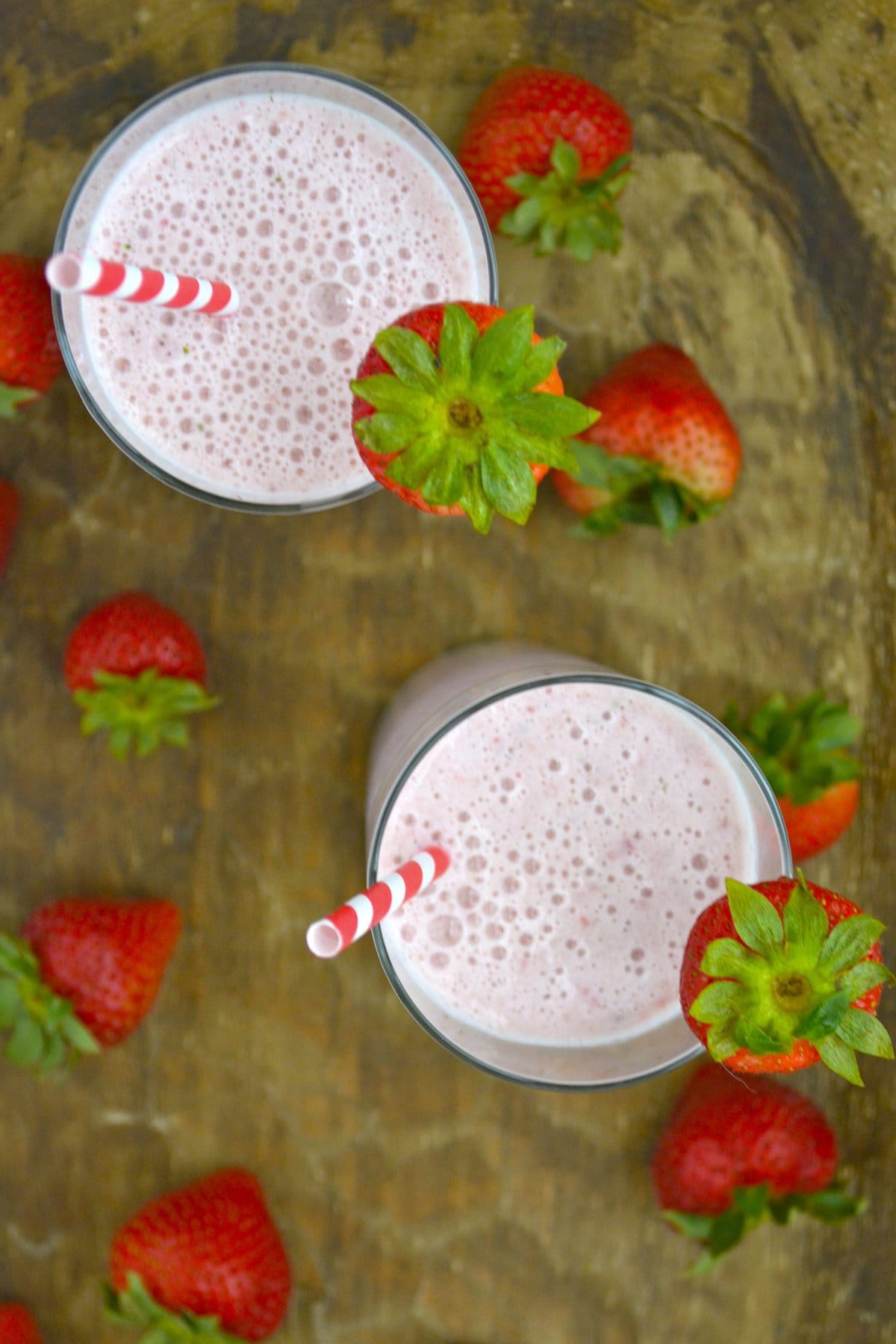overhead view of two glasses of fresh strawberry milk