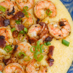 Cheesy Shrimp and Grits are the ultimate southern meal! Cheesy grits, spicy shrimp, crispy bacon and fresh green onions are perfect comfort food!