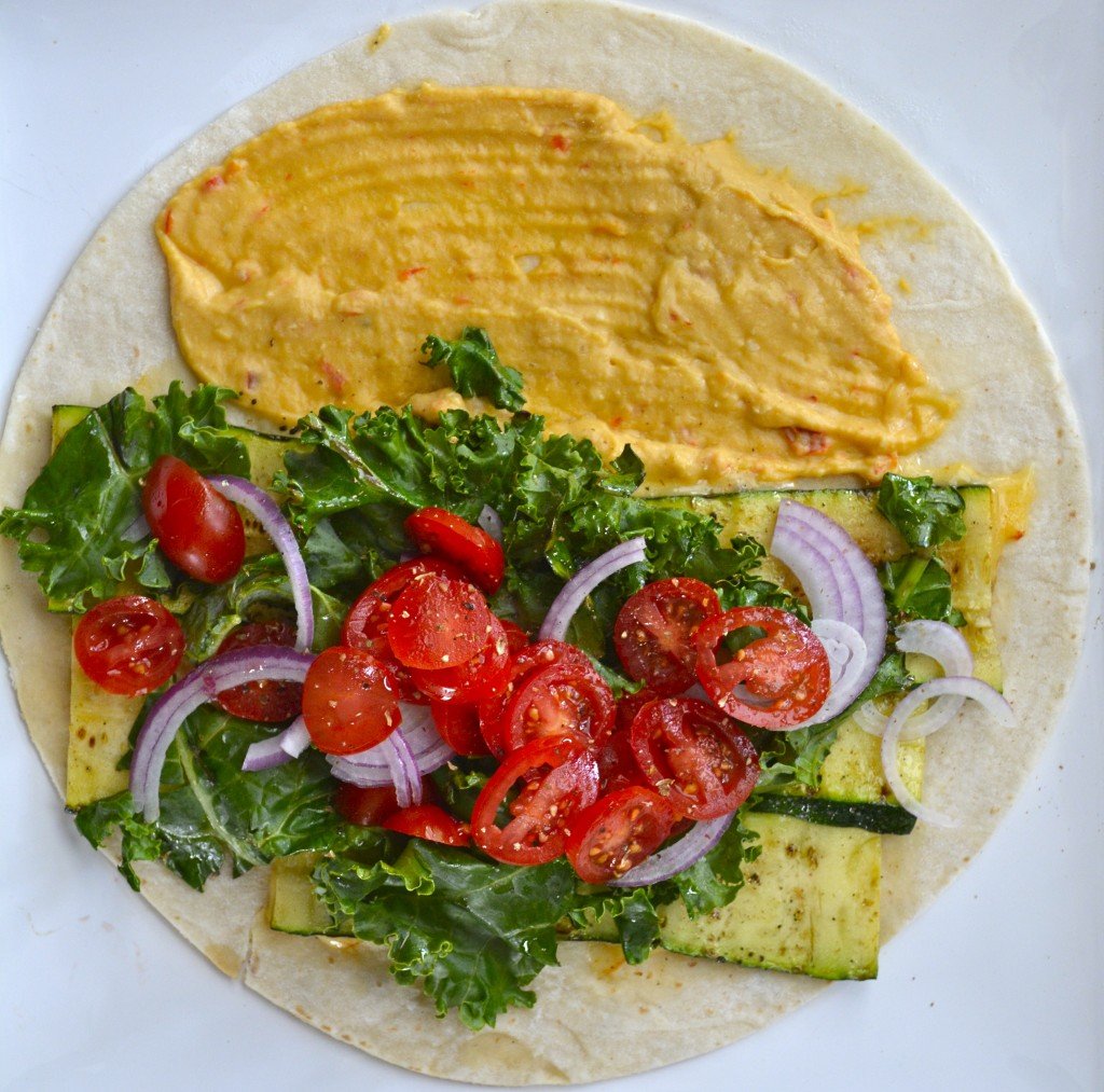 overhead view of a hummus veggie wrap before it's been rolled up 