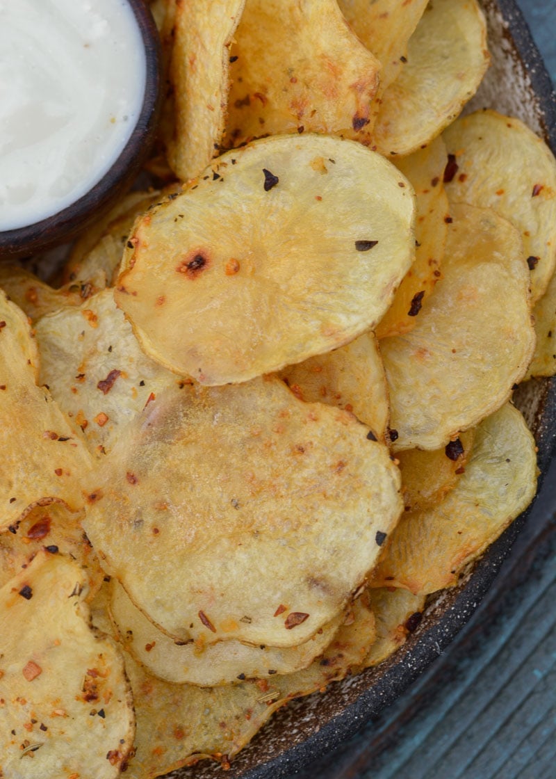 crispy potato chips seasoned with Kickin' Chicken seasoning and piled on a plate with ranch dressing