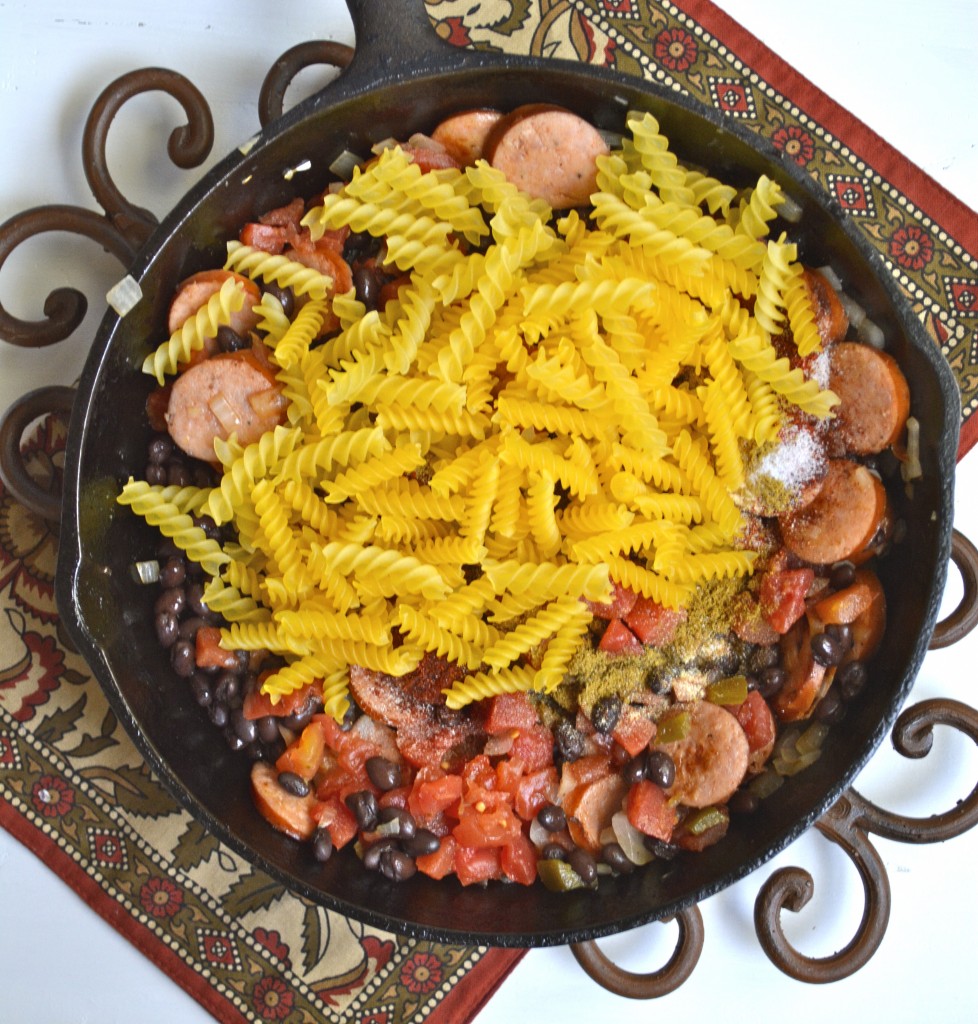 This easy One Pan Pasta is a quick, 30-minute meal that is packed with Spicy Sausage and Black Beans! The perfect one-dish family dinner!