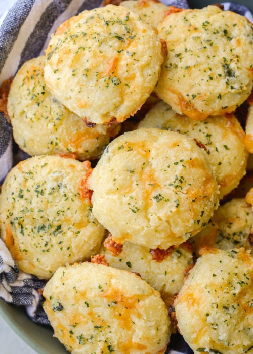 These Keto Three Cheese Biscuits are perfectly soft and fluffy! Each low carb biscuit is loaded with sharp cheddar cheddar, mozzarella and fresh basil for just 2 net carbs each!  