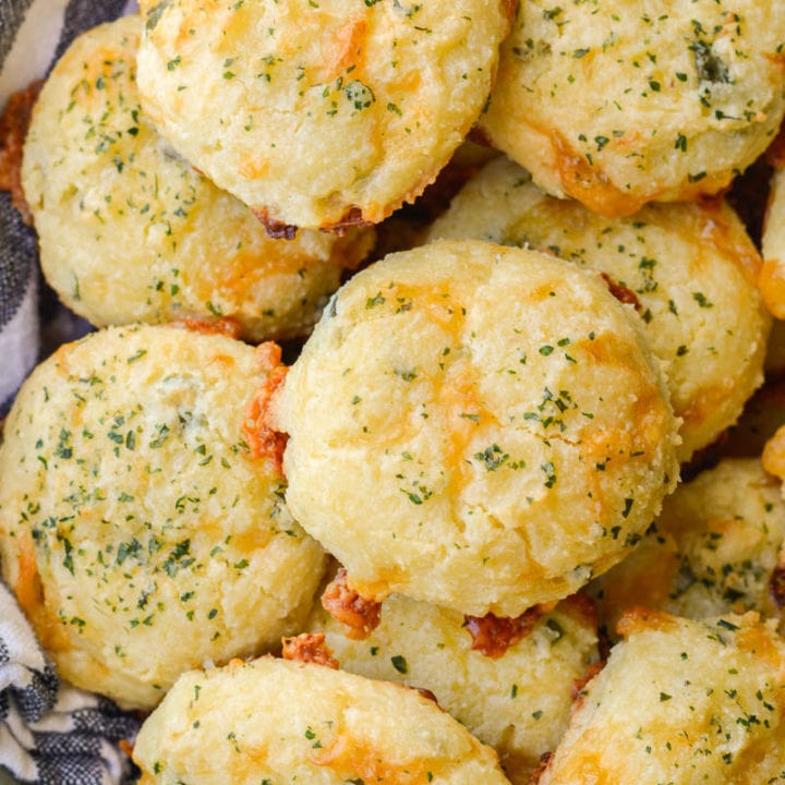 These Keto Three Cheese Biscuits are perfectly soft and fluffy! Each low carb biscuit is loaded with sharp cheddar cheddar, mozzarella and fresh basil for just 2 net carbs each!  