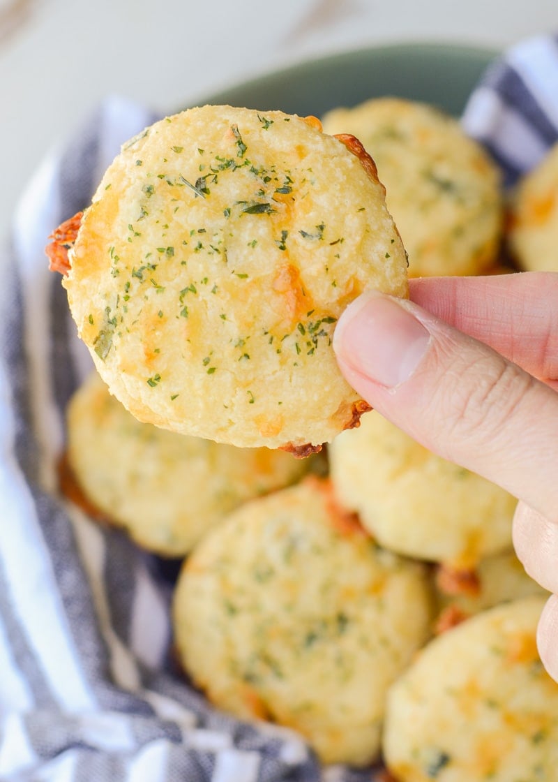 These Keto Three Cheese Biscuits are perfectly soft and fluffy! Each low carb biscuit is loaded with sharp cheddar cheddar, mozzarella and fresh basil for just 2 net carbs each!