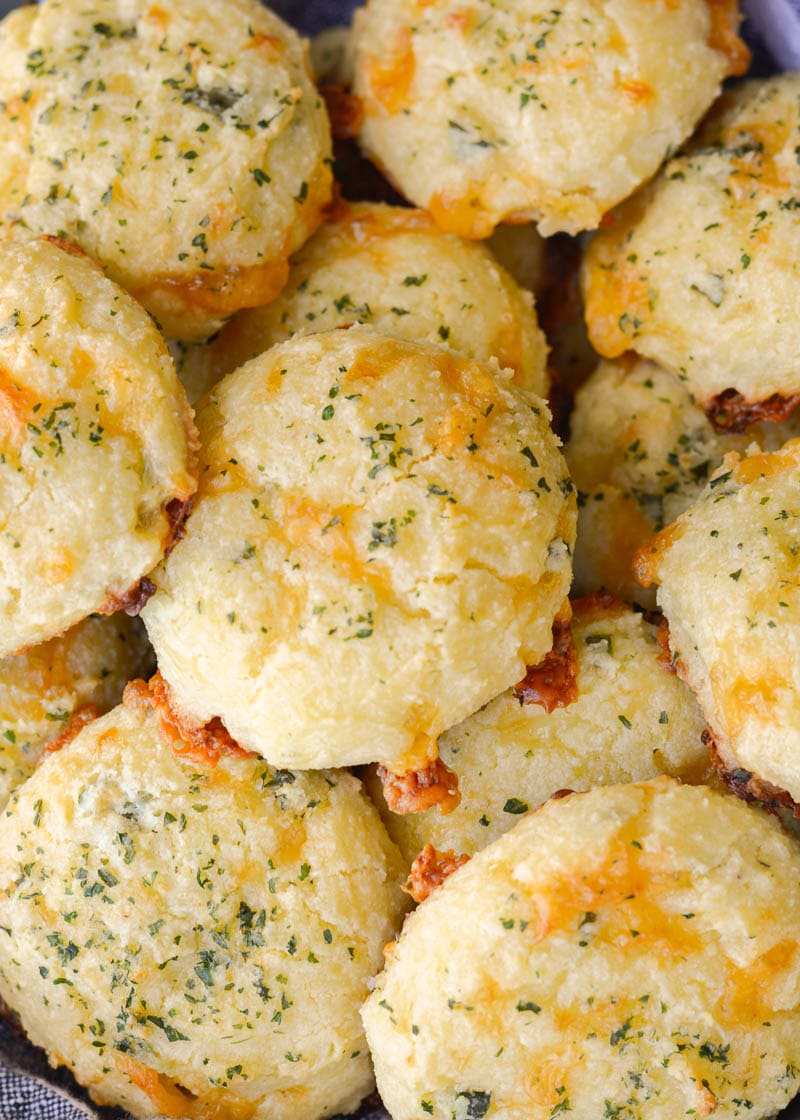 These Keto Three Cheese Biscuits are perfectly soft and fluffy! Each low carb biscuit is loaded with sharp cheddar cheddar, mozzarella and fresh basil for just 2 net carbs each!