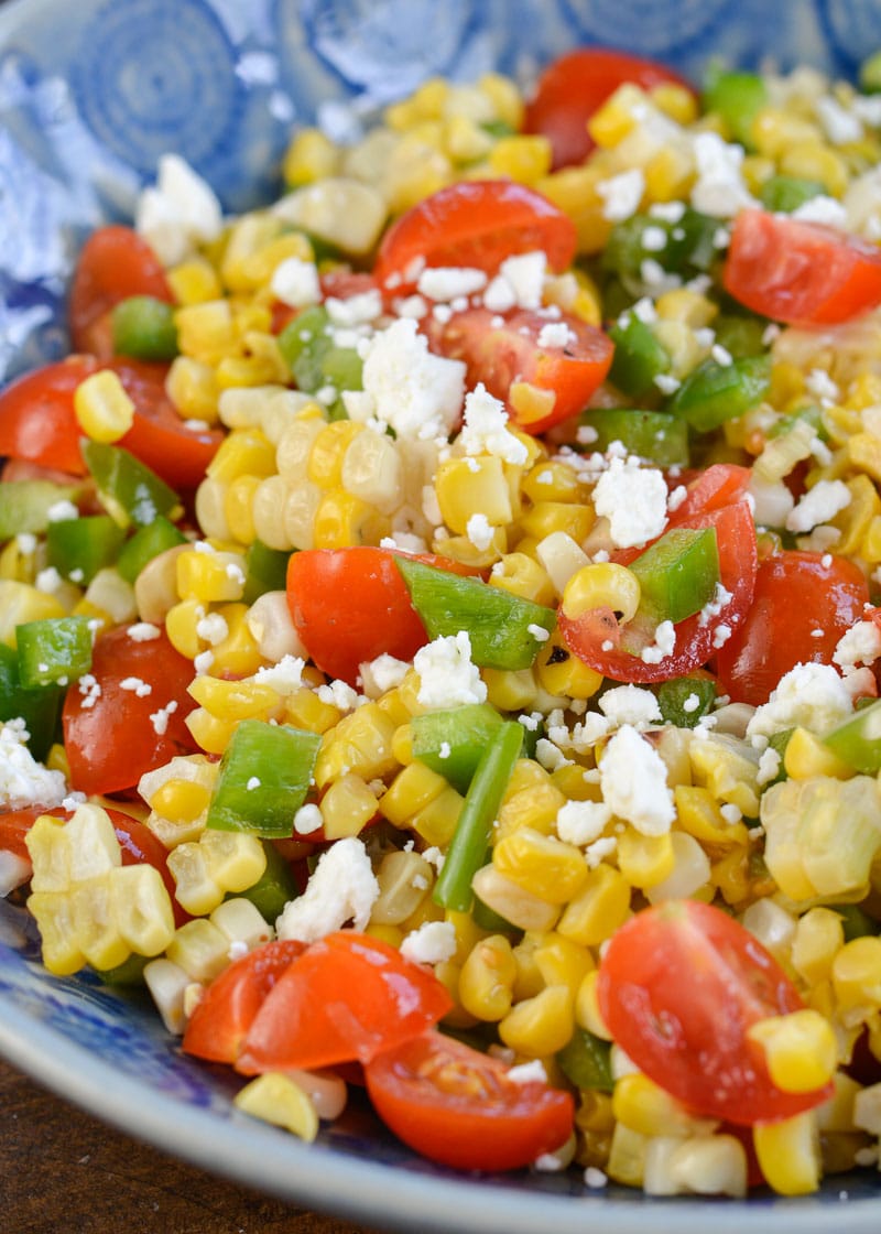 Make this Corn and Tomato Salad recipe for your next potluck or BBQ. It's a quick and easy summer side dish that everyone loves!