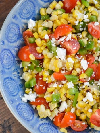 Make this Corn and Tomato Salad recipe for your next potluck or BBQ. It's a quick and easy summer side dish that everyone loves!