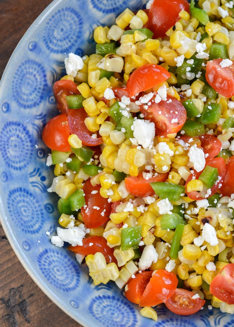 Make this Corn and Tomato Salad recipe for your next potluck or BBQ. It's a quick and easy summer side dish that everyone loves!