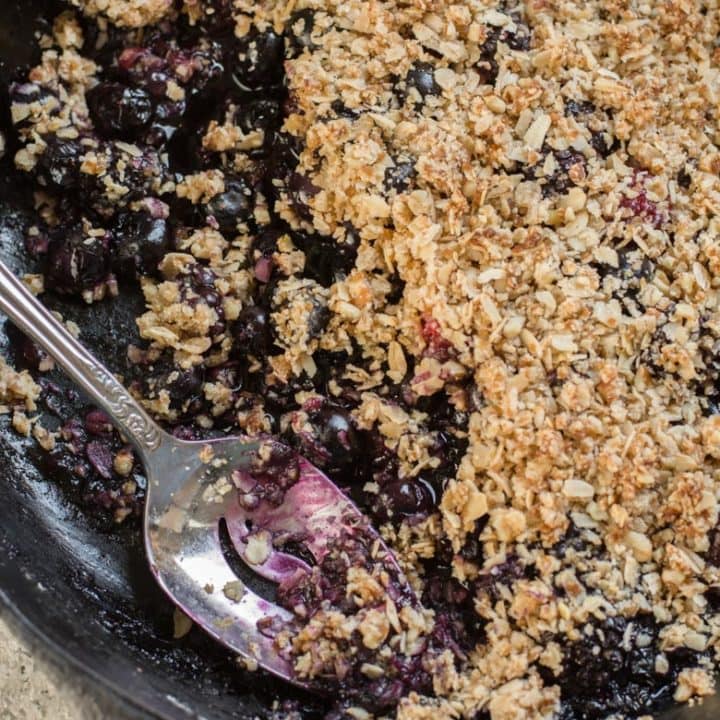 This Berry Crisp with Oatmeal Crumble Topping features warm, sweet blueberries and blackberries with a crisp oatmeal crumble topping! Top with ice cream for an ultra satisfying dessert!