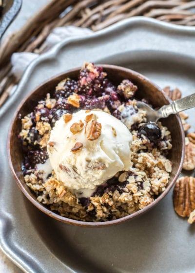 This Berry Crisp with Oatmeal Crumble Topping features warm, sweet blueberries and blackberries with a crisp oatmeal crumble topping! Top with ice cream for an ultra satisfying dessert!