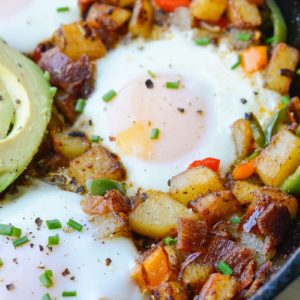 This Mexican Breakfast Hash is loaded with seasoned, crisp potatoes, peppers, onions, bacon and eggs! This is the perfect one pan breakfast recipe! 