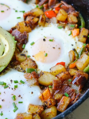 This Mexican Breakfast Hash is loaded with seasoned, crisp potatoes, peppers, onions, bacon and eggs! This is the perfect one pan breakfast recipe! 