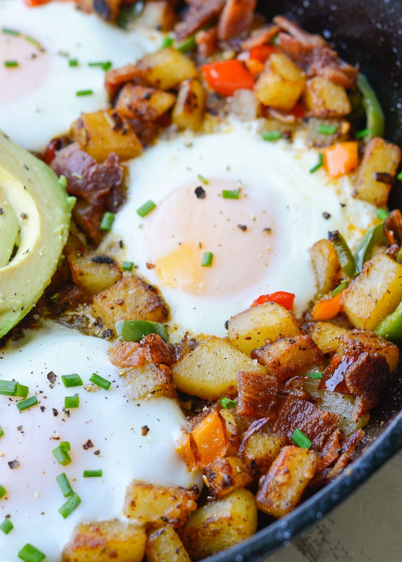 This Mexican Breakfast Hash is loaded with seasoned, crisp potatoes, peppers, onions, bacon and eggs! This is the perfect one pan breakfast recipe! 