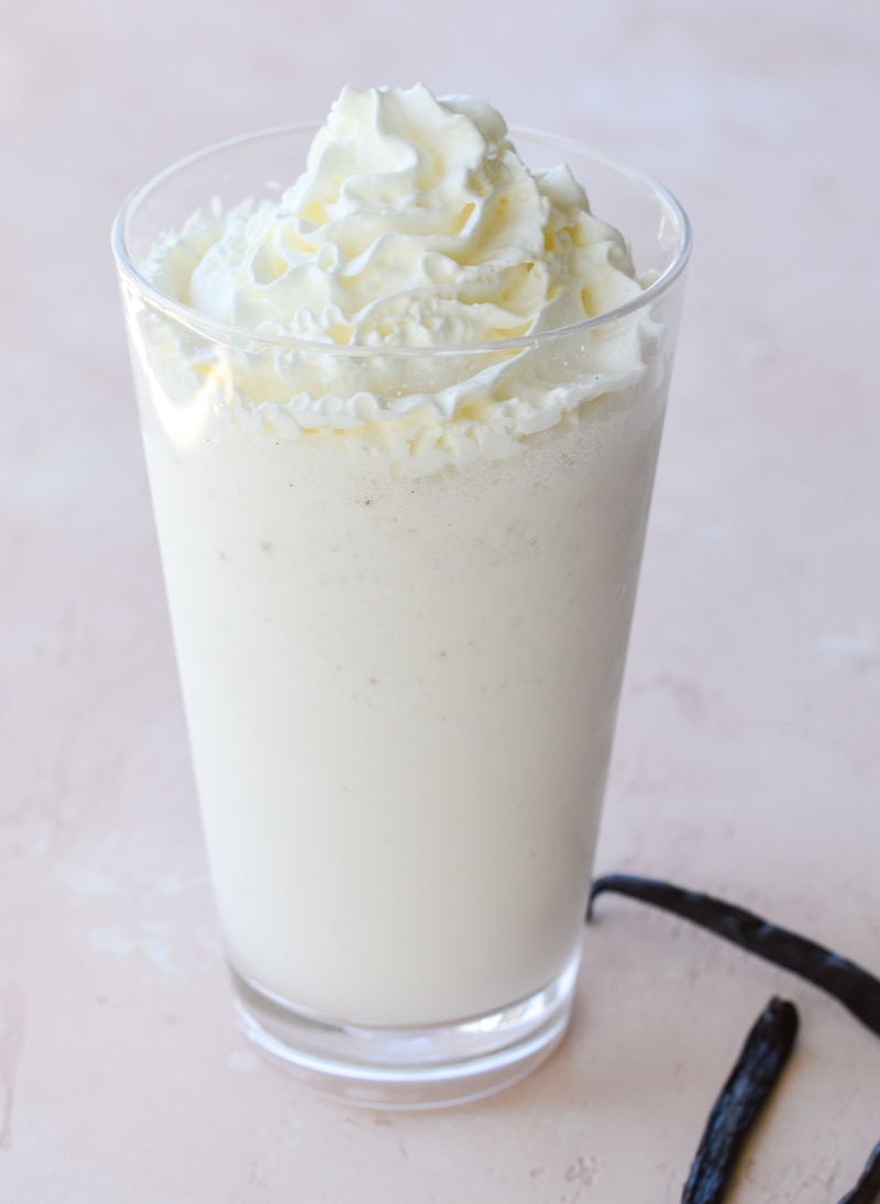 A homemade vanilla bean frappe in a tall glass. 