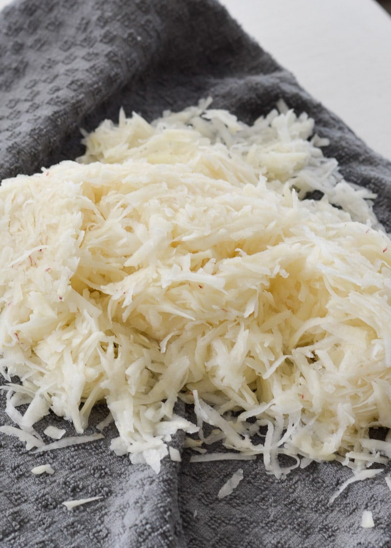 A pile of shredded potatoes in a tea towel.