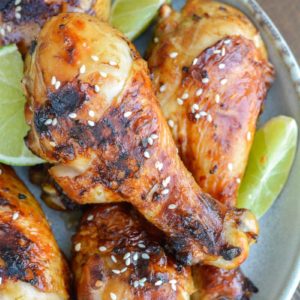 Grilled Chicken Legs are the perfect easy dinner recipe! This chicken is marinaded in an Asian sauce that pairs perfectly with grilled vegetables!