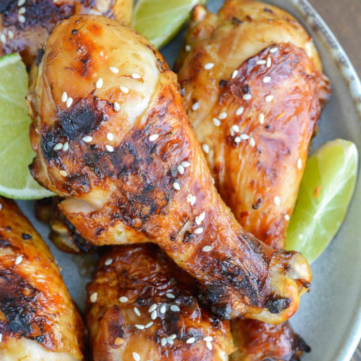 Grilled Chicken Legs are the perfect easy dinner recipe! This chicken is marinaded in an Asian sauce that pairs perfectly with grilled vegetables!