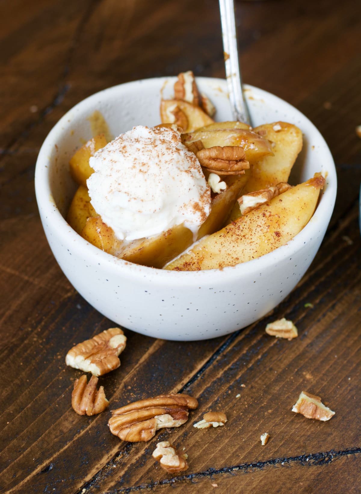 serving of crockpot spiced apples a la mode in a white bowl