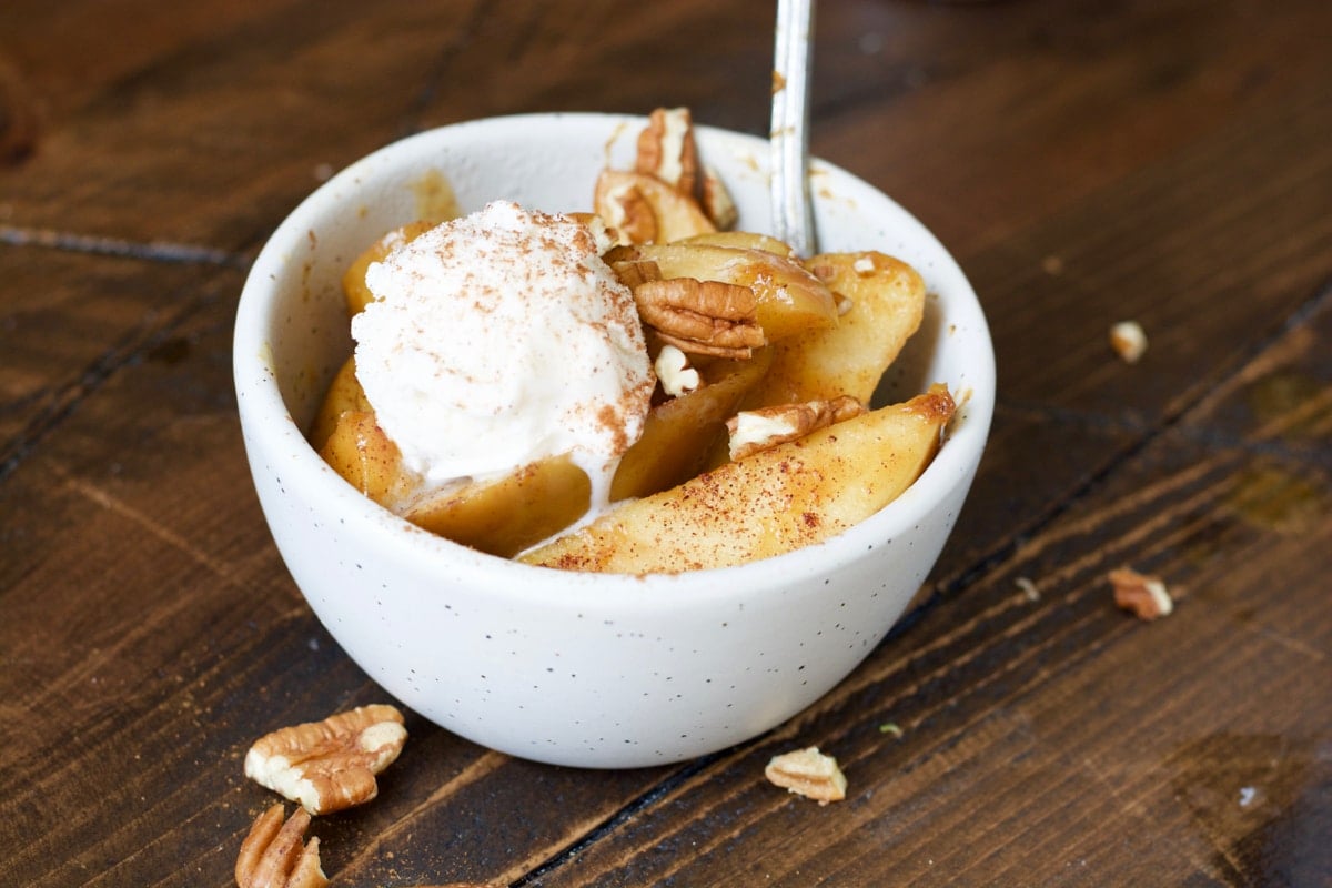 serving of crockpot spiced apples a la mode in a white bowl
