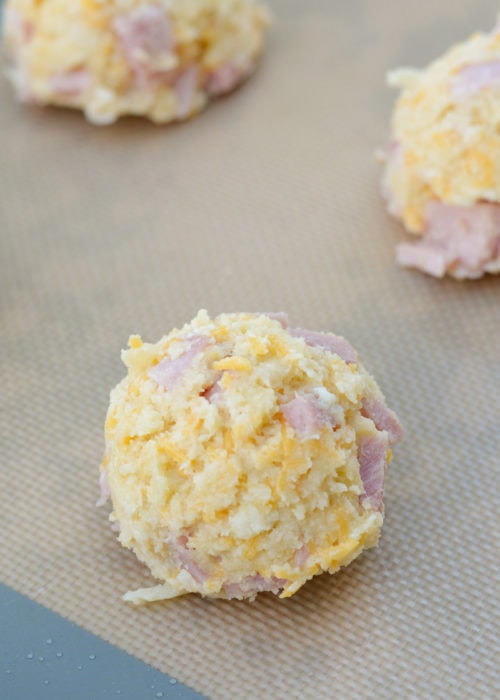 Use an ice cream scoop to perfectly portion these gluten-free keto ham and swiss biscuits. Roll into a ball for even cooking.
