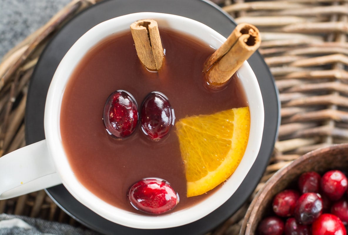  This Cranberry Pineapple Tea is full of mulled spices like cinnamon and cloves along with fresh fruit. This festive tea is essential for holiday entertaining! 