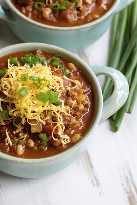 cabbage and black eyed pea soup in two blue soup dishes 