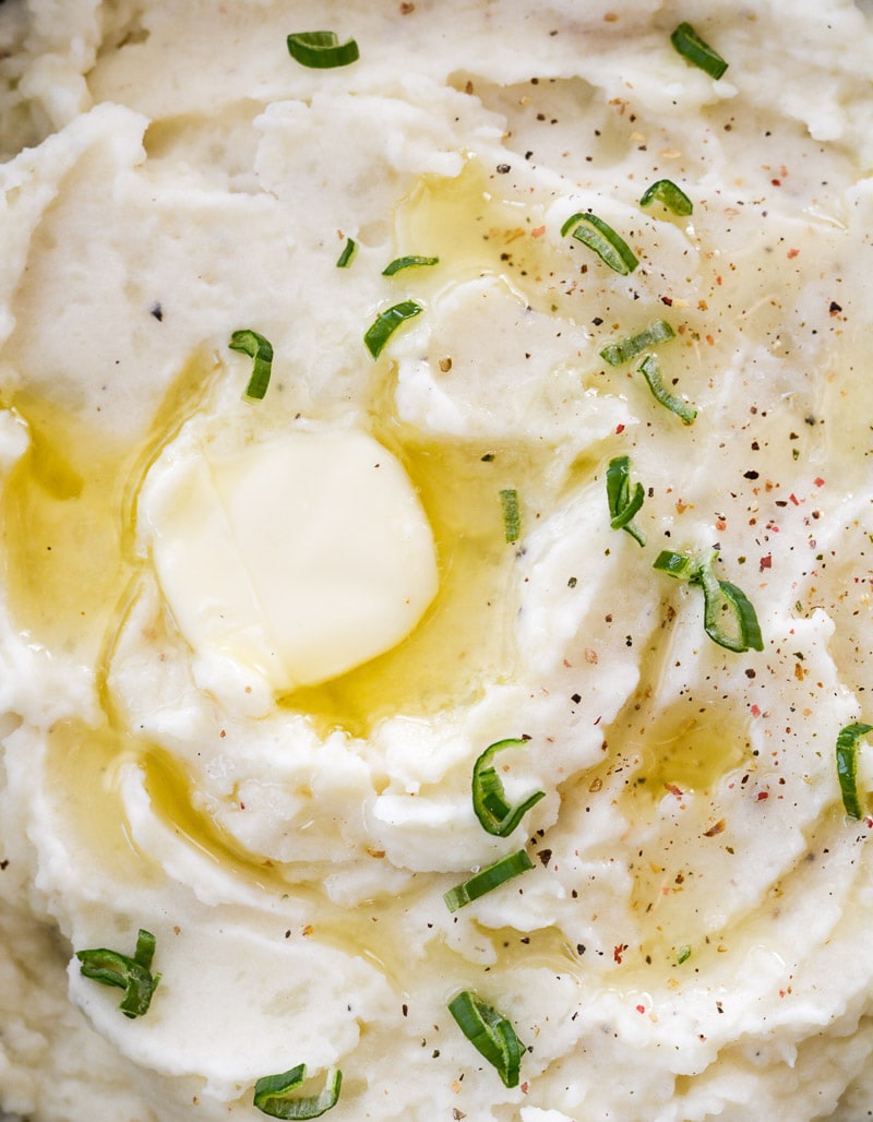 overhead view of mashed potatoes with a pat of butter 