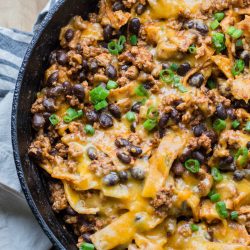 This super easy One Pan Enchilada dish will become a family favorite! Ground beef, black beans, a flavorful enchilada sauce, tortillas and cheese come together for a simple one pan, 20 minute meal! 