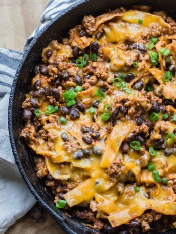 This super easy One Pan Enchilada dish will become a family favorite! Ground beef, black beans, a flavorful enchilada sauce, tortillas and cheese come together for a simple one pan, 20 minute meal! 