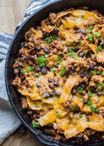 This super easy One Pan Enchilada dish will become a family favorite! Ground beef, black beans, a flavorful enchilada sauce, tortillas and cheese come together for a simple one pan, 20 minute meal! 