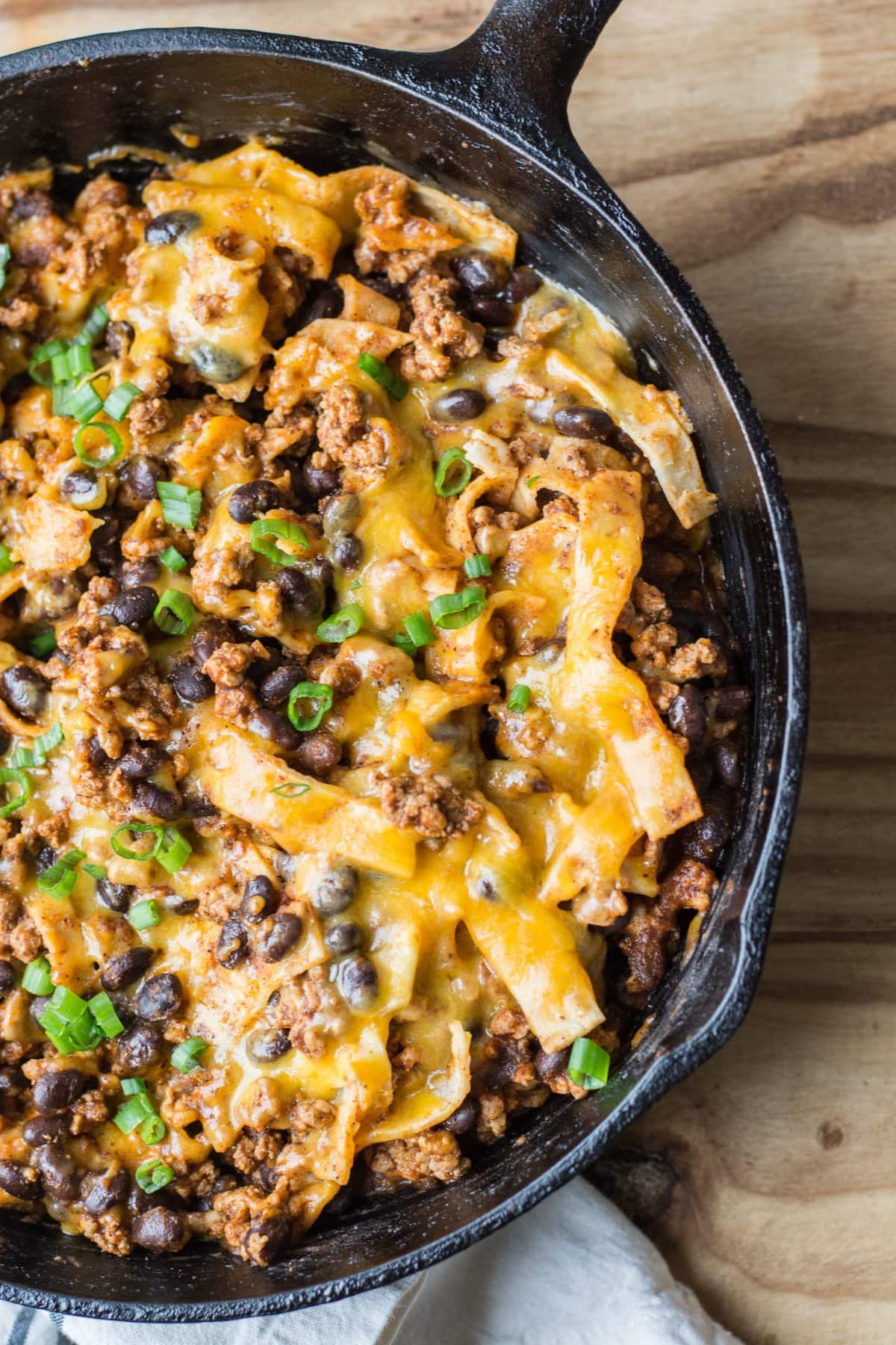 This super easy One Pan Enchilada dish will become a family favorite! Ground beef, black beans, a flavorful enchilada sauce, tortillas and cheese come together for a simple one pan, 20 minute meal! 