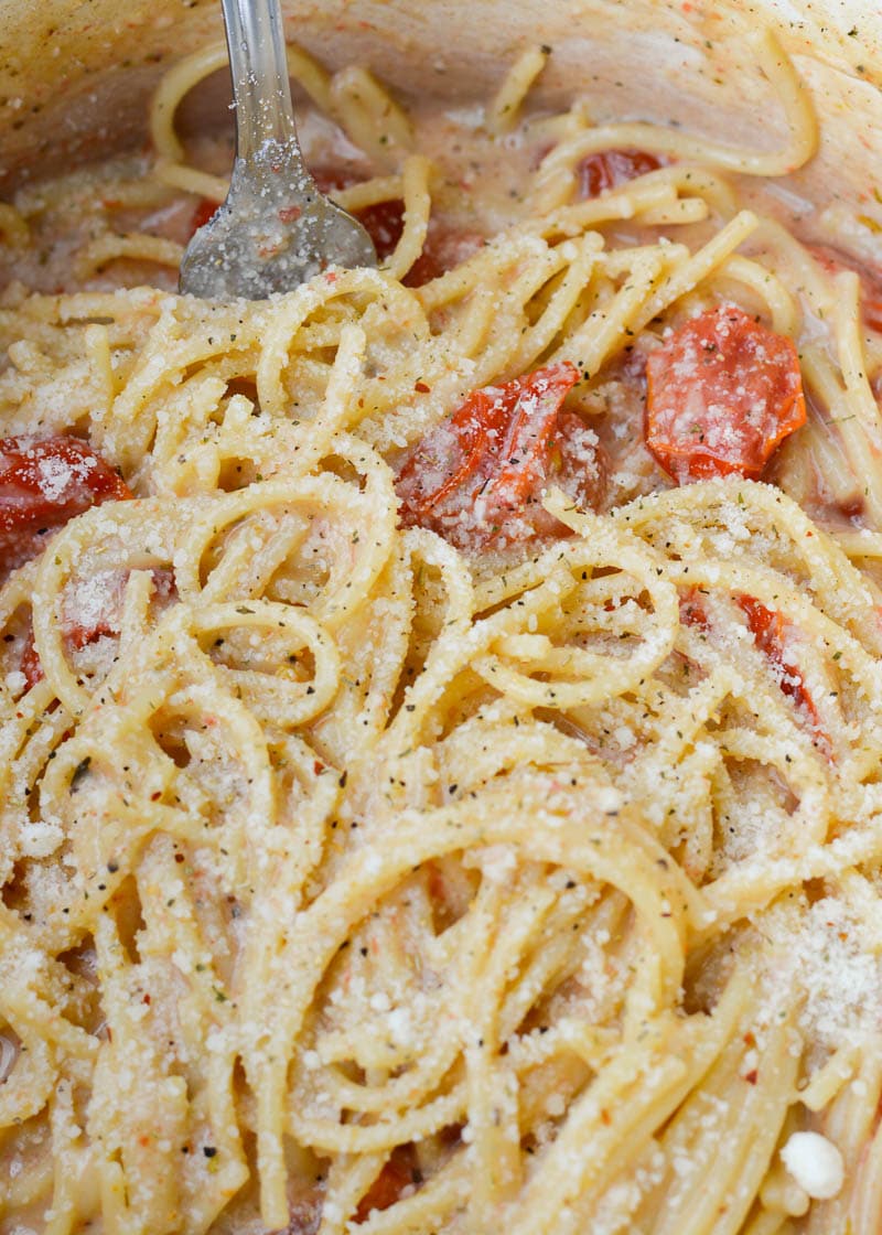 This Garlic Parmesan Pasta is going to become a weeknight favorite! Gluten free pasta is covered in a creamy wine sauce and topped with cherry tomatoes and is ready in only 20 minutes!