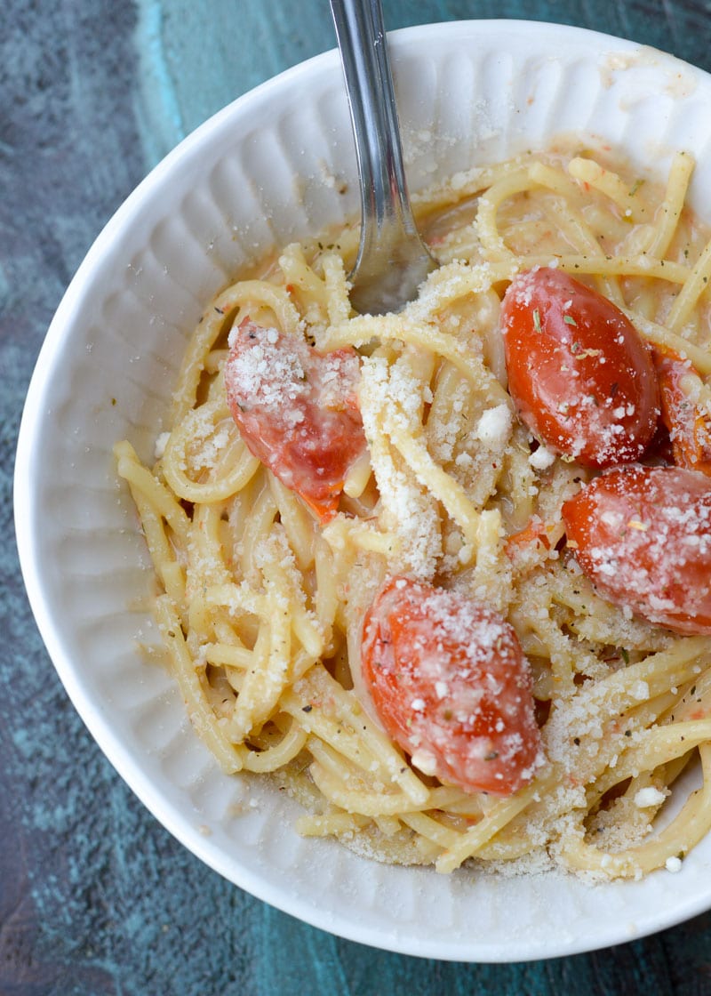 This Garlic Parmesan Pasta is going to become a weeknight favorite! Gluten free pasta is covered in a creamy wine sauce and topped with cherry tomatoes and is ready in only 20 minutes!