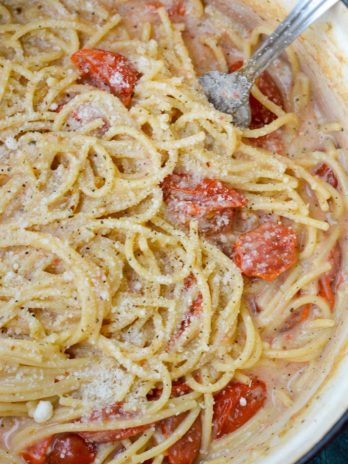 This Garlic Parmesan Pasta is going to become a weeknight favorite! Gluten free pasta is covered in a creamy wine sauce and topped with cherry tomatoes and is ready in only 20 minutes!