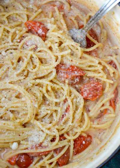 This Garlic Parmesan Pasta is going to become a weeknight favorite! Gluten free pasta is covered in a creamy wine sauce and topped with cherry tomatoes and is ready in only 20 minutes!