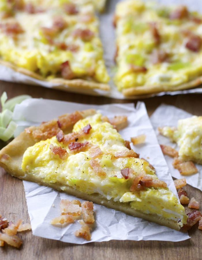 Crispy gluten free crust is topped with scrambled eggs, sautéed leeks, sharp white cheddar and bacon for an easy dinner, or breakfast! 