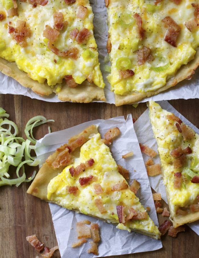 Crispy gluten free crust is topped with scrambled eggs, sautéed leeks, sharp white cheddar and bacon for an easy dinner, or breakfast! 