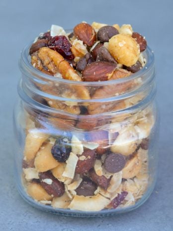 This Grain Free Granola with Cranberries is packed with rich dark chocolate, tart cranberries coconut, nuts, and seeds! It is the perfect grab-and-go snack for any occasion!