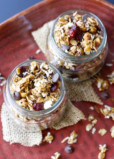 This loaded granola is packed with rich dark chocolate, tart cranberries, cinnamon coconut, nuts, and seeds! It is the perfect grab and go snack for any occasion!